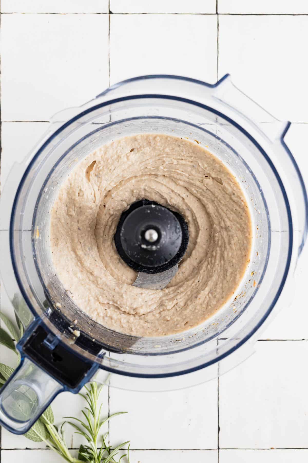 Smooth Tuscan bean dip in a food processor.
