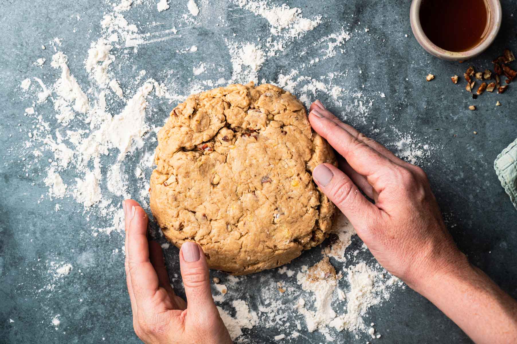 Shaping vegan banana scones into a round disk.
