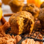 Baked pumpkin banana muffins with a bite taken out of one.