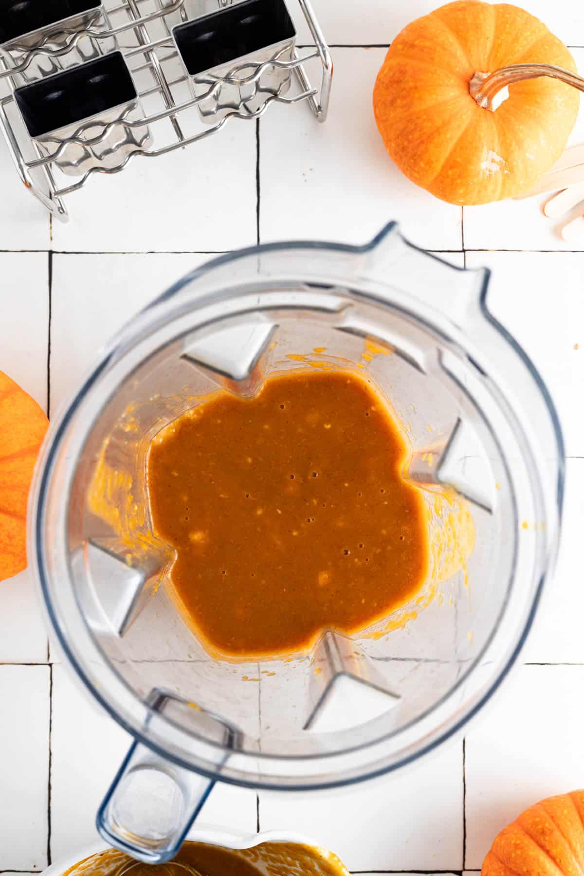 Mixture for pumpkin pie popsicles in a blender.