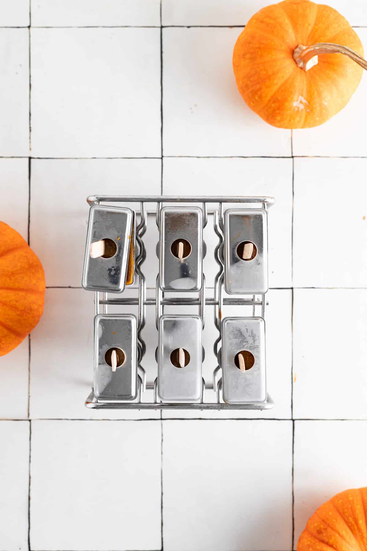 Stainless steel tops and popsicle sticks added to the stainless steel mold.