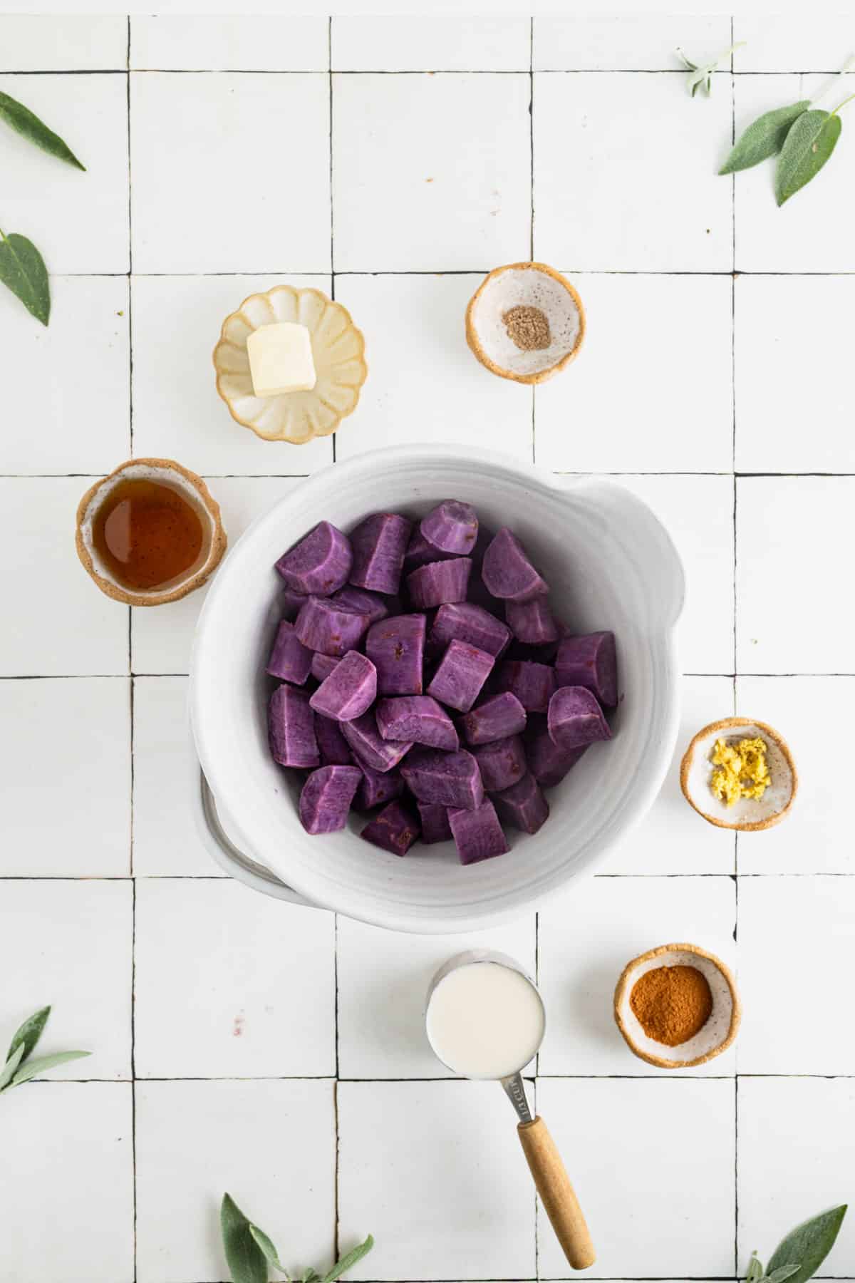 Cooked cubed sweet potatoes in a large white mixing bowl.