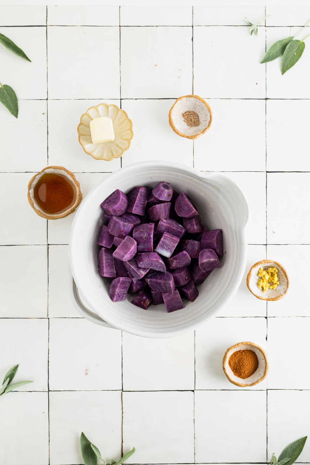 Cooked cubed sweet potatoes in a large white mixing bowl.