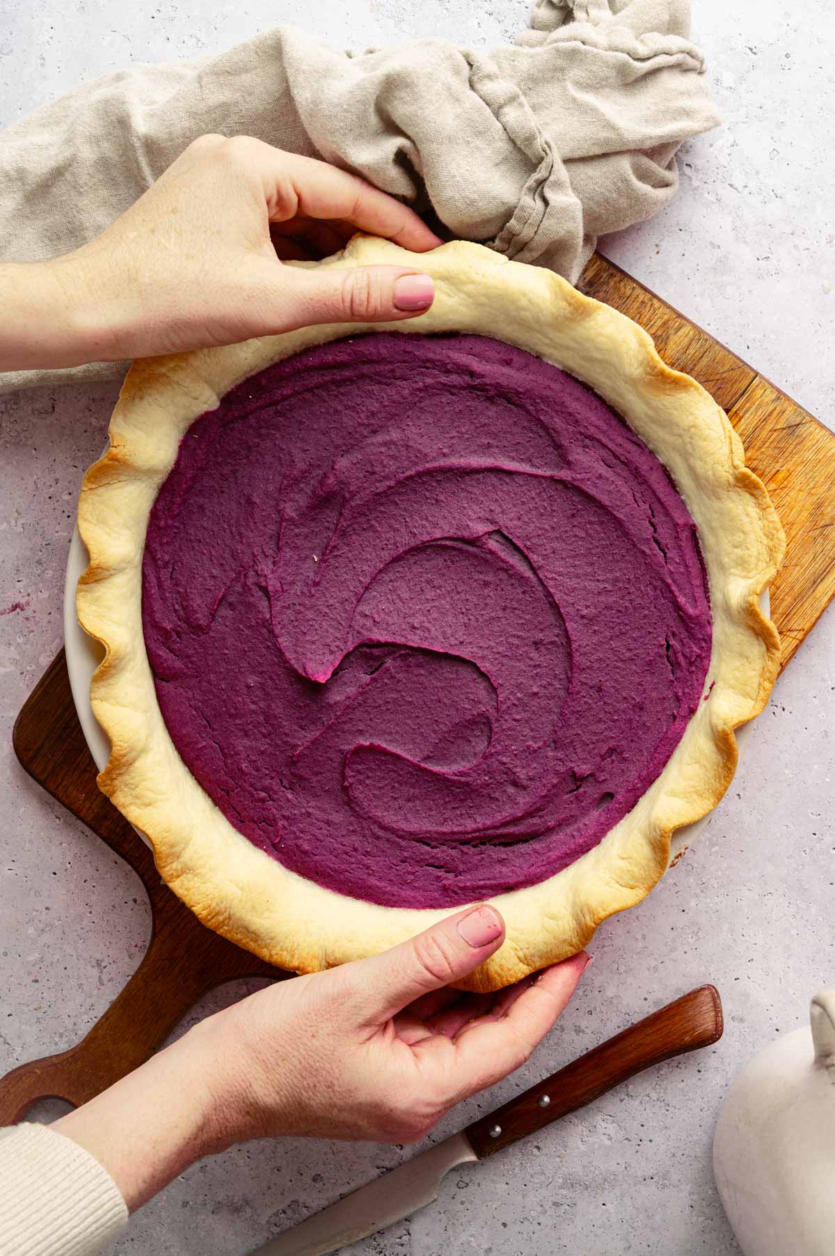 Woman reaching for vegan sweet potato pie.