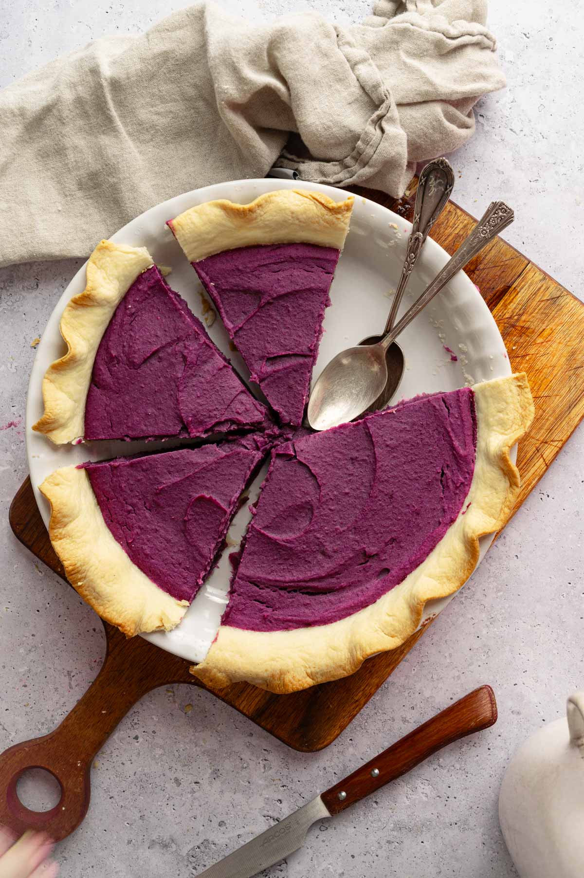 Vegan purple sweet potato pie cut into pieces.