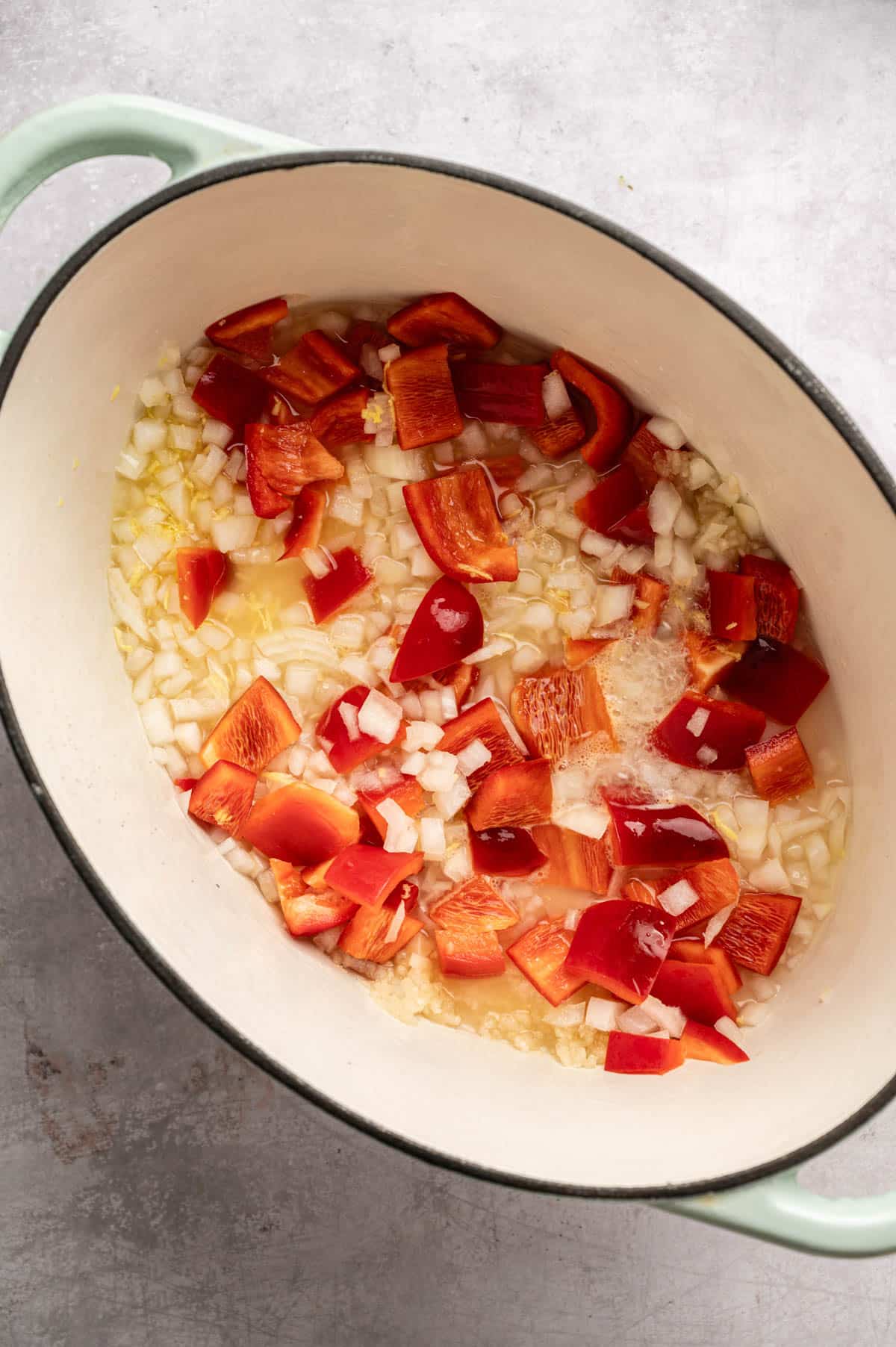 Sautéing onion, ginger, garlic, and bell pepper.