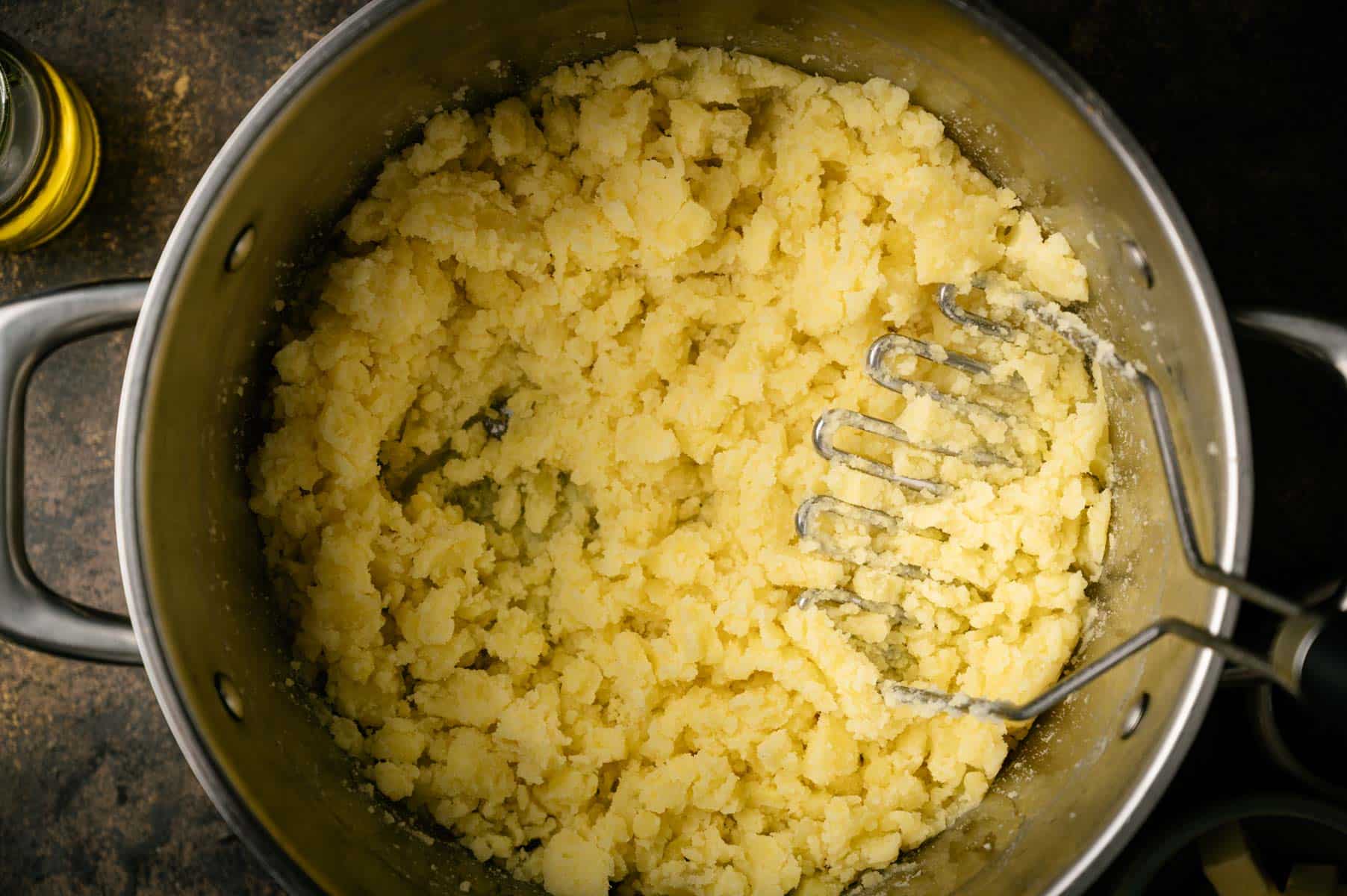 Potatoes mashed in a large pot.