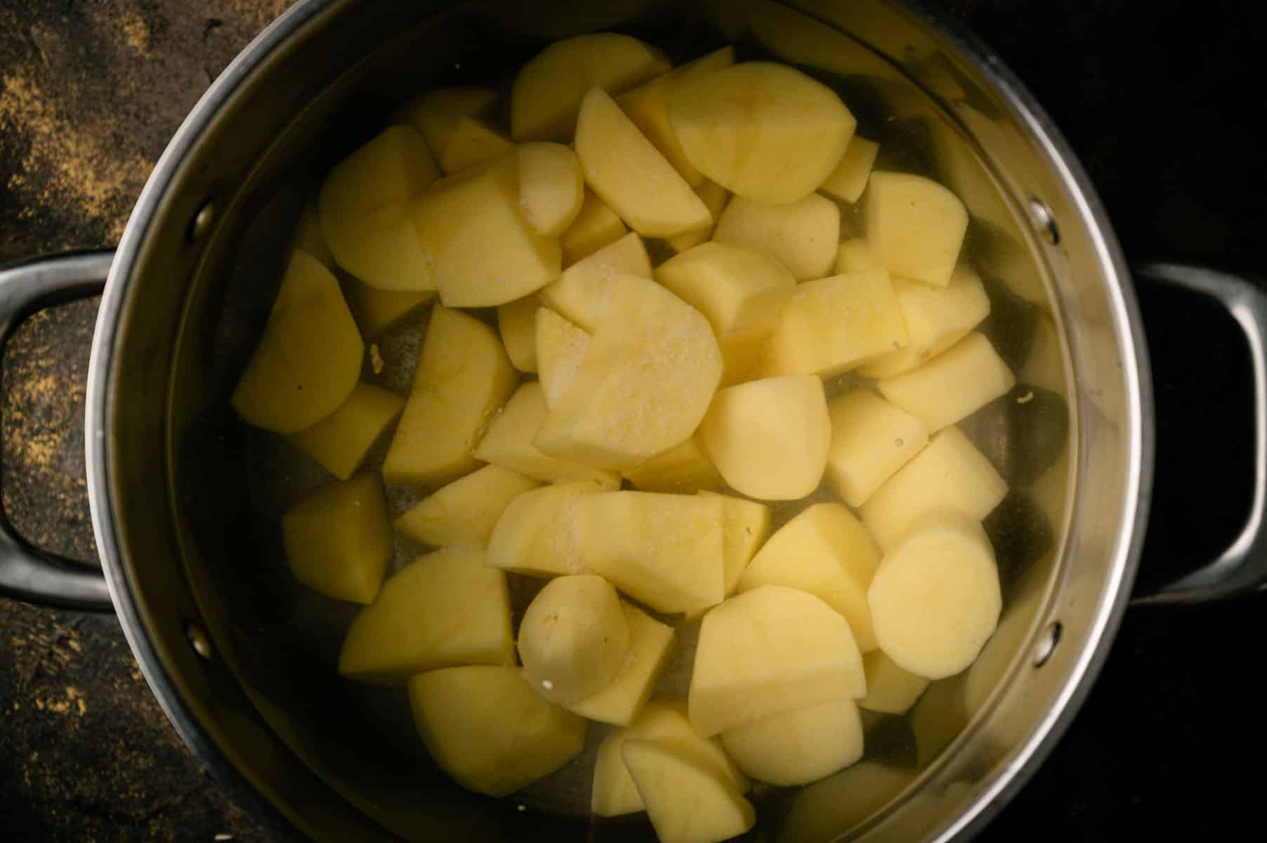 Boiling the potato cubes.