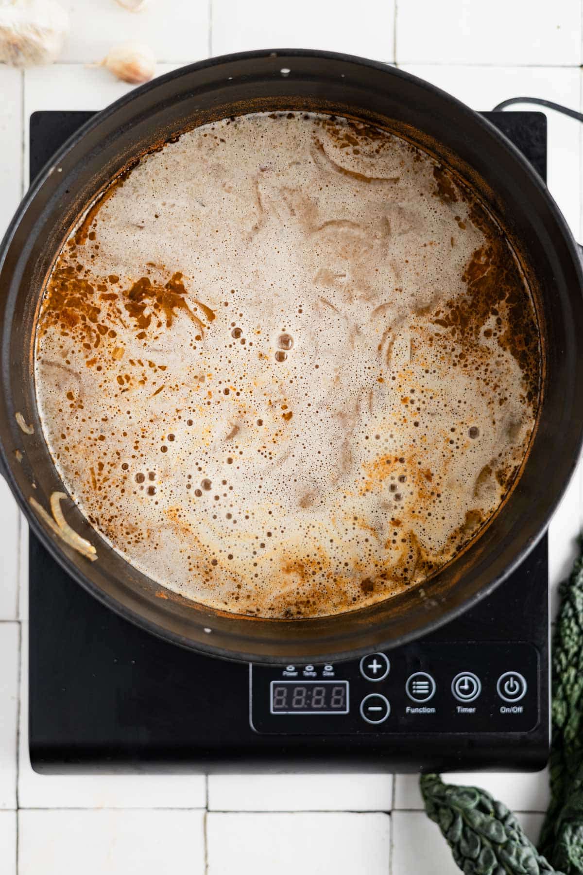 Pureed soup poured into soup pot.