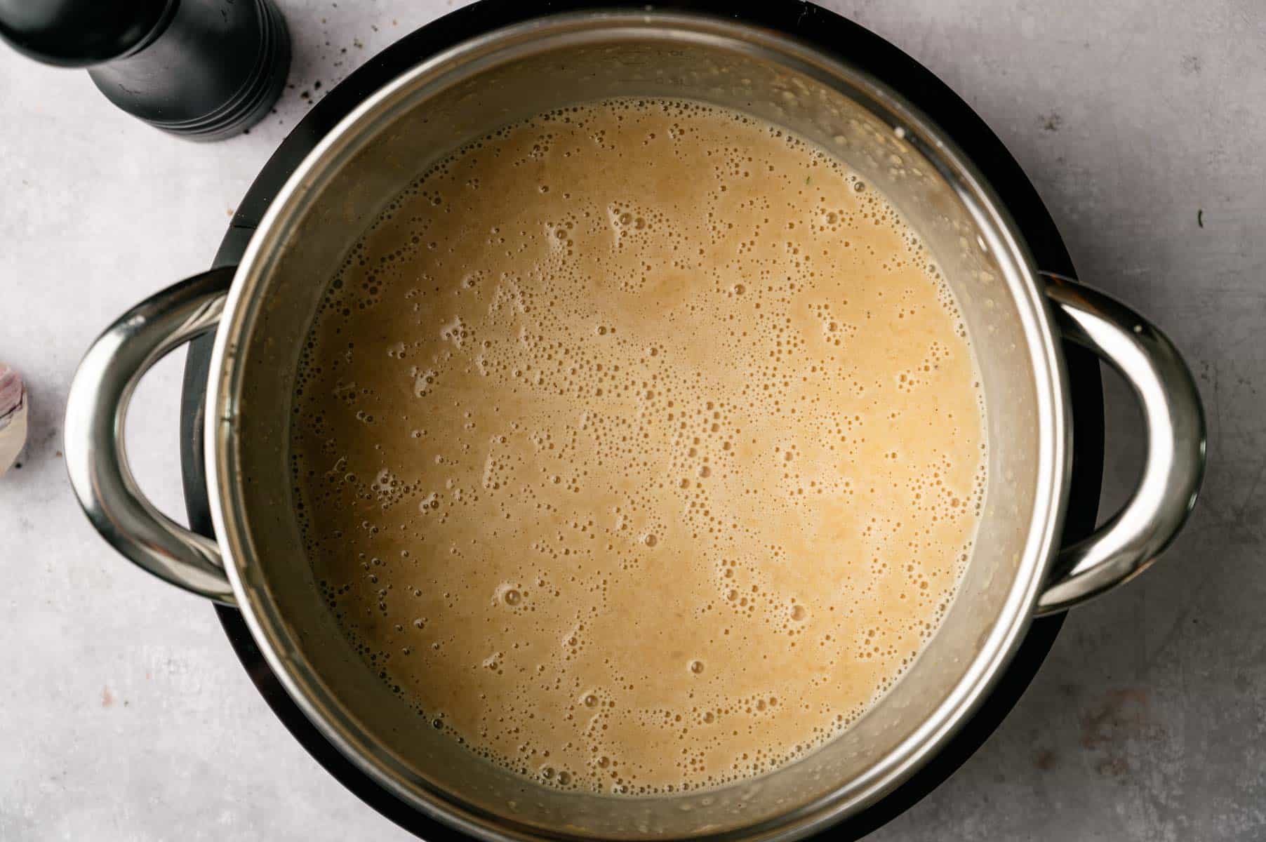 Vegan gravy simmering in a soup pot.