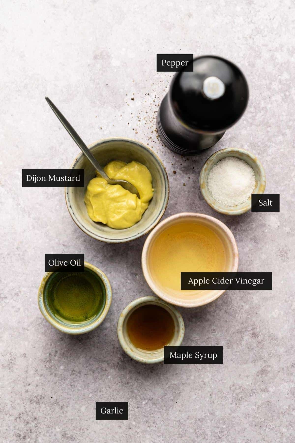 Ingredients Dijon maple syrup salad dressing with each ingredient labeled.