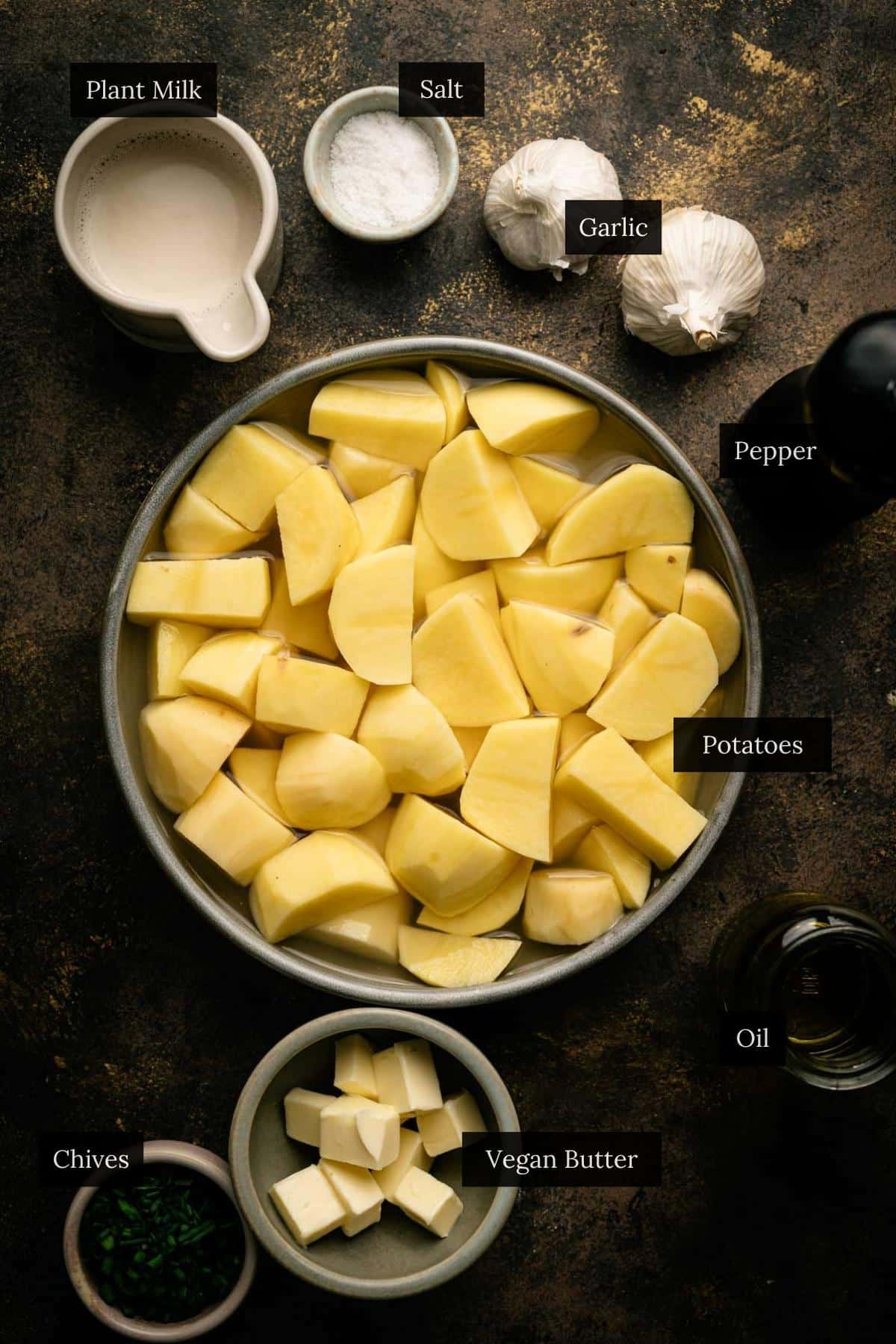 Ingredients for a easy vegan mashed potatoes with each ingredient labeled.