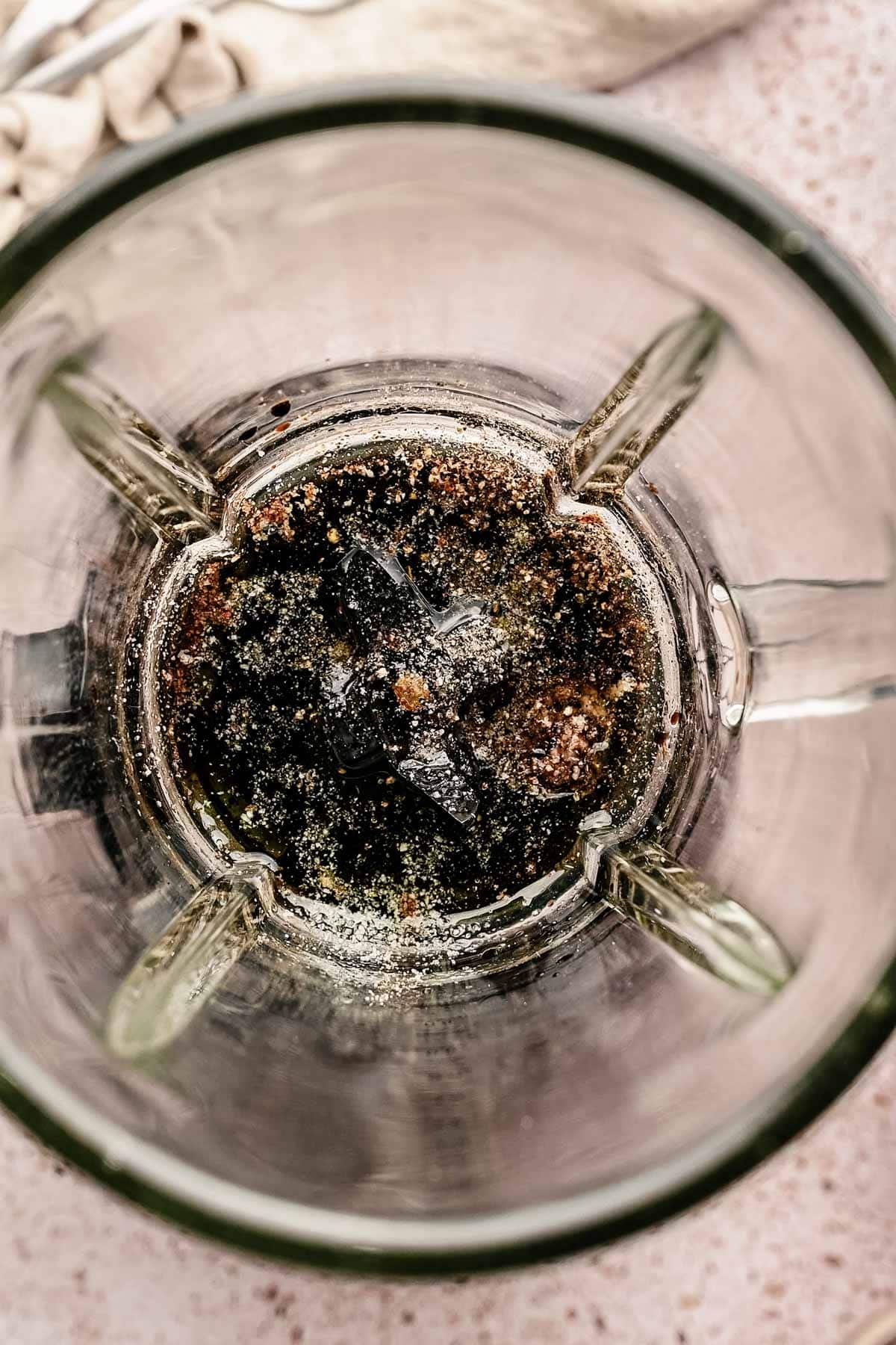 Adding salt, pepper, garlic, oil, and vinegar to blender.