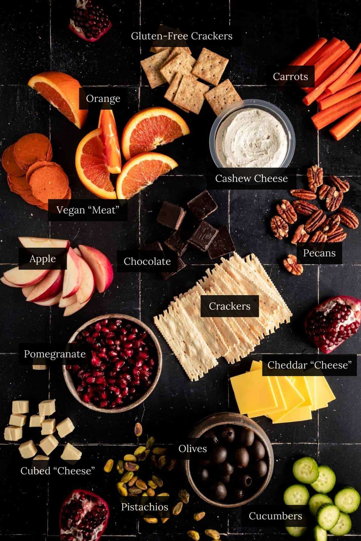 Ingredients for a homemade fall charcuterie board with each ingredient labeled.