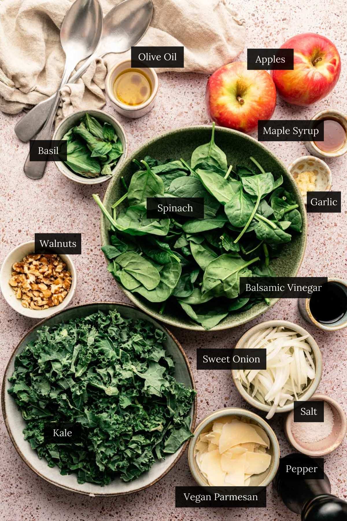 Ingredients for a kale spinach salad recipe with each ingredient labeled.
