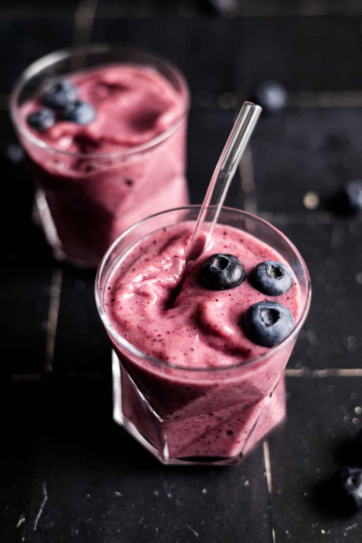 Two cups of blueberry and strawberry banana smoothie.