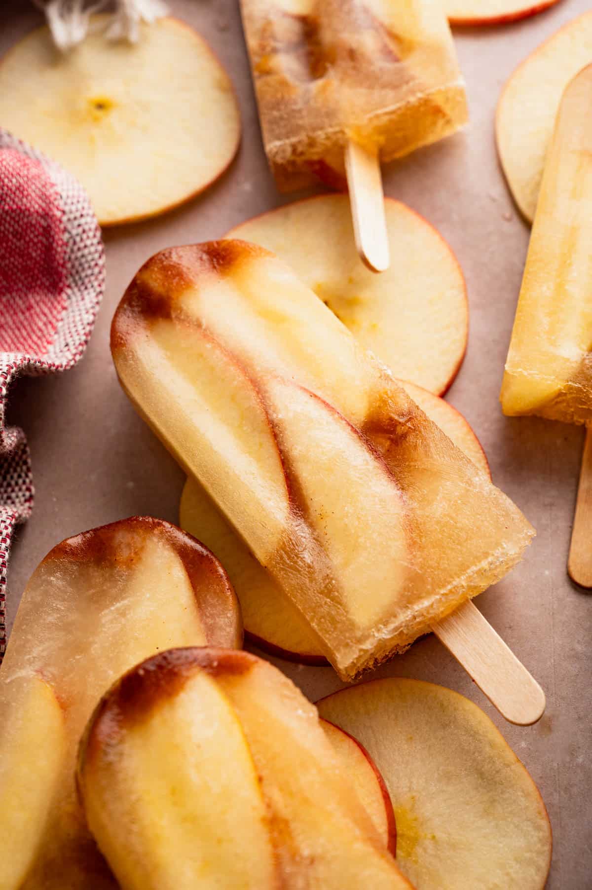 Homemade apple popsicles with apple slices inside.