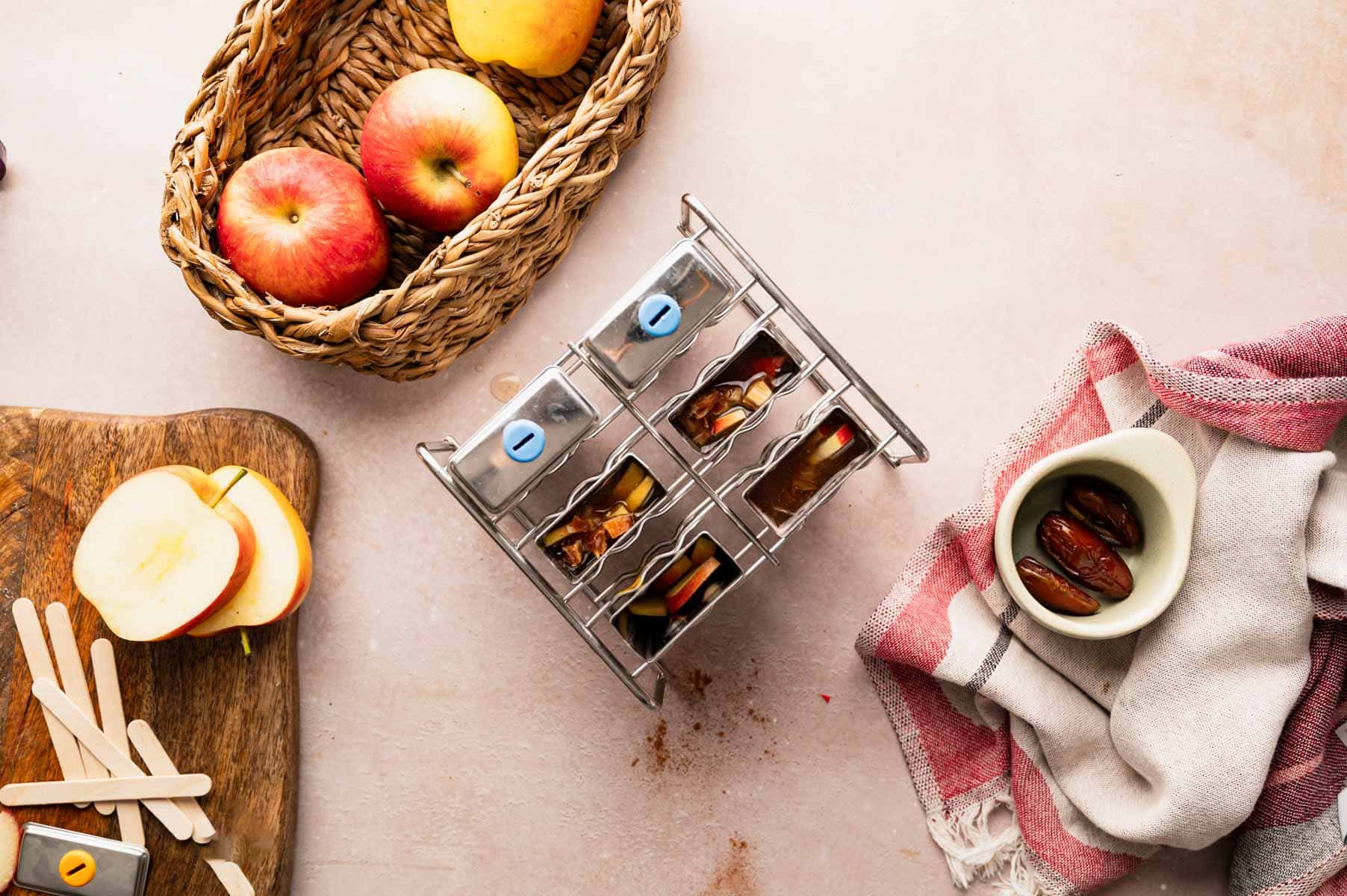 Adding apples to popsicles mold.